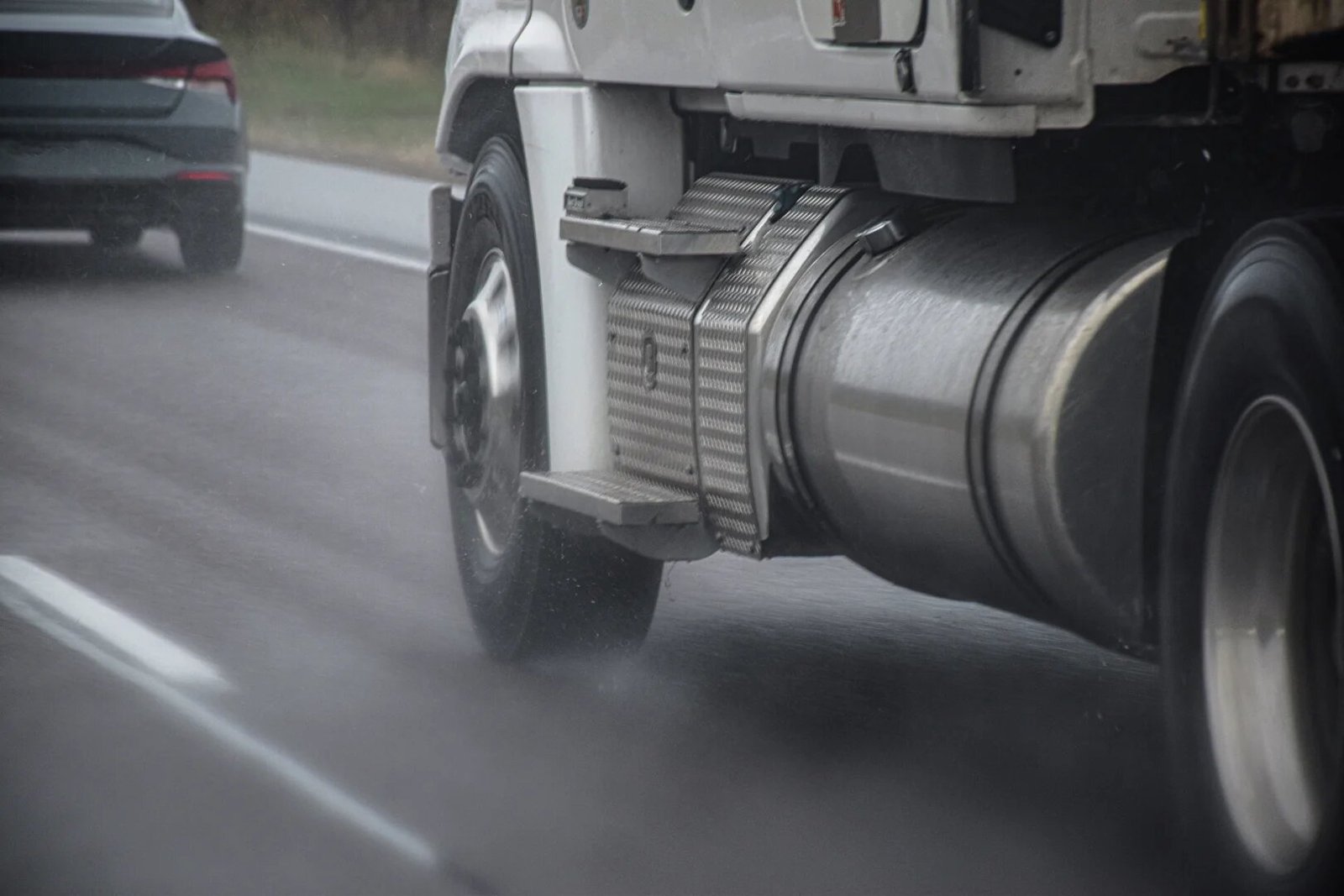 A large commercial truck navigating heavy traffic on Interstate 85 near Spaghetti Junction in Atlanta
