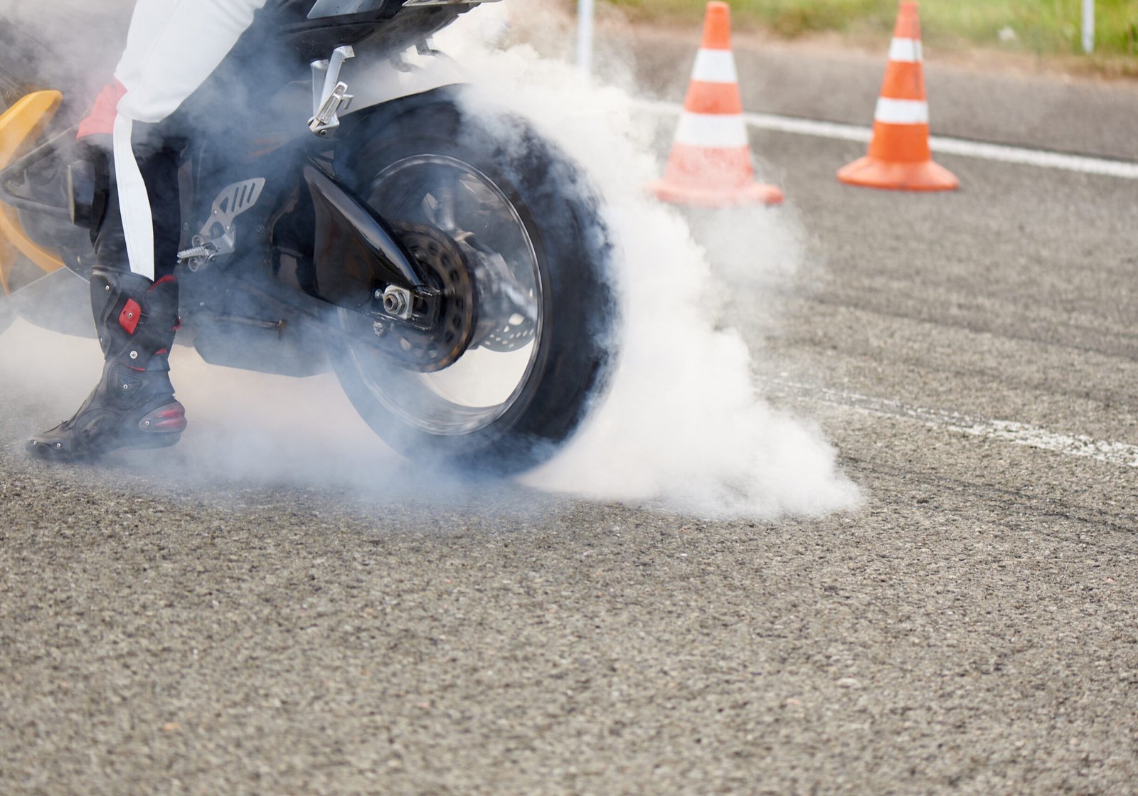 Young man on a motorcycle in the smoke on the race track.